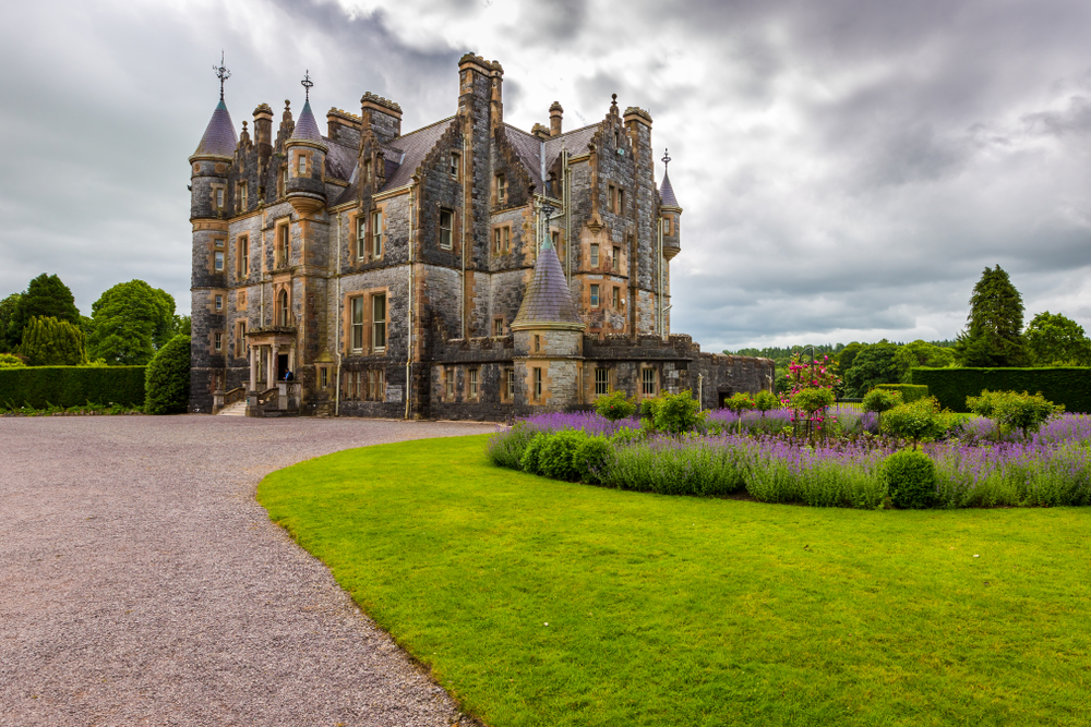 Coudy day at Blarney Castle with flowers in the lawn.