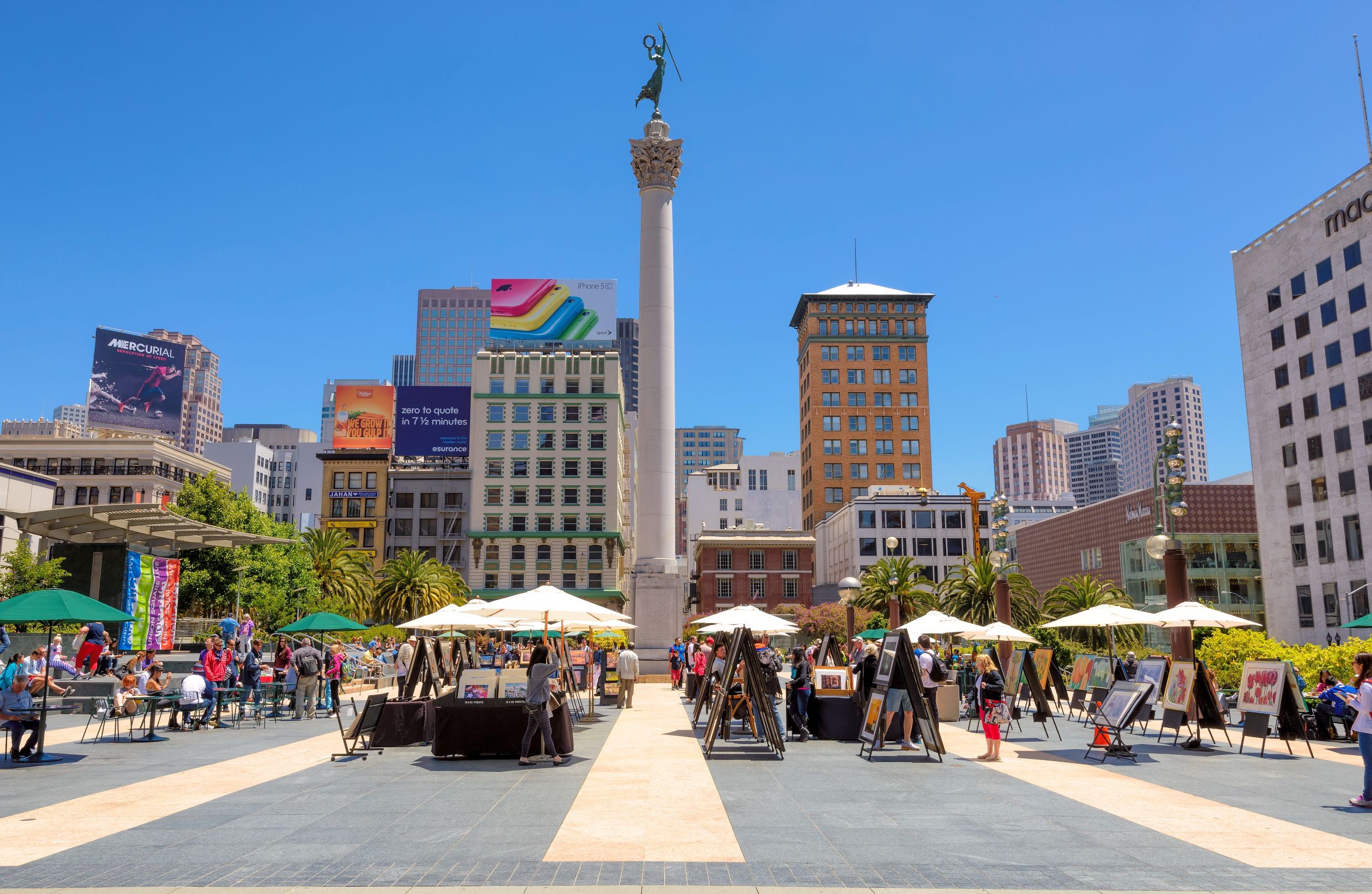 Photo of Union Square in, one of the best places to stay in San Francisco. Photo features main tall buildings with a main square holding an art show.