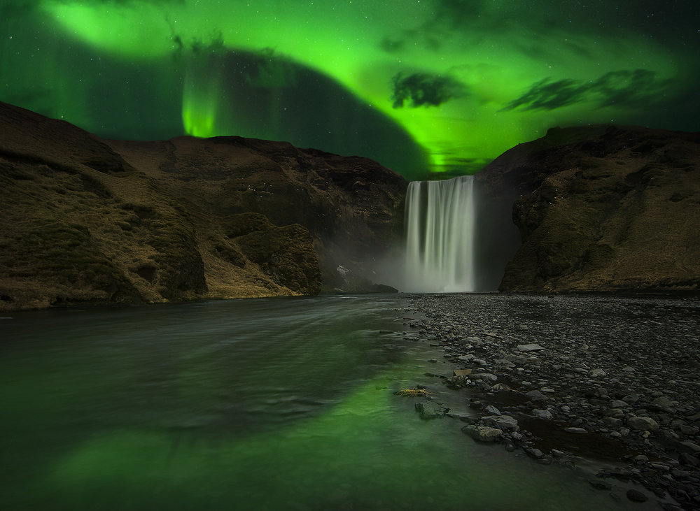the Northern Lights over Skogafoss during your trip to Iceland in September