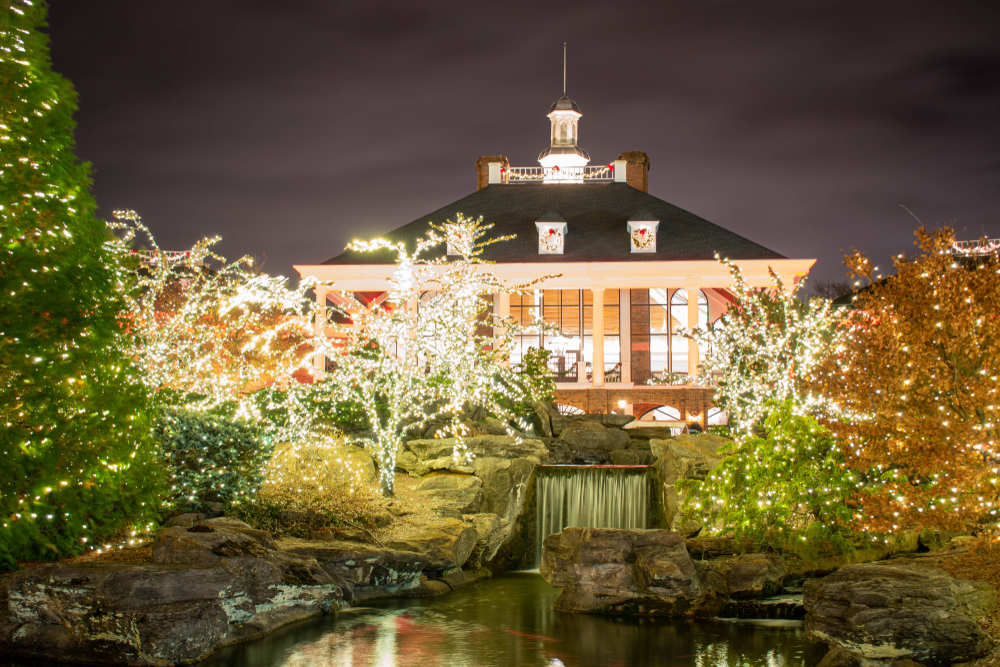 Outside the Gaylord Opryland Hotel with trees covers in Christmas lights and a waterfall.