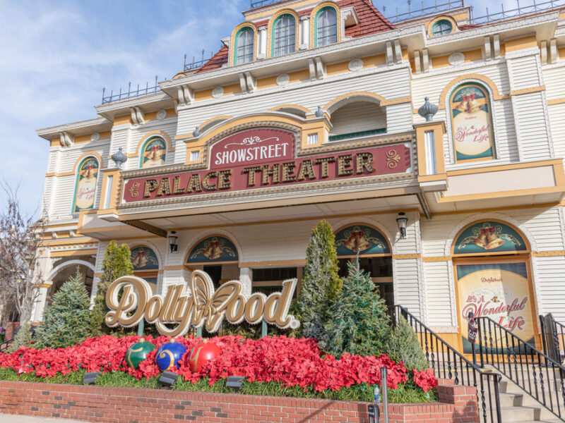 A front facing view of the Palace Theater at Dollywood with the park's Dollywood sign, the word spelled out with a butterfly in place of the "W."