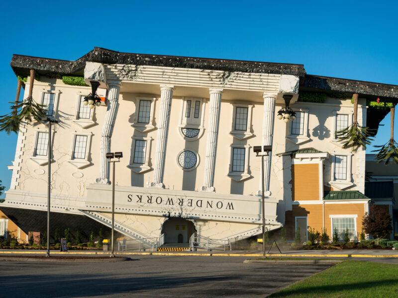 An upside down building with Greek style column reads "Wonderworks."s.