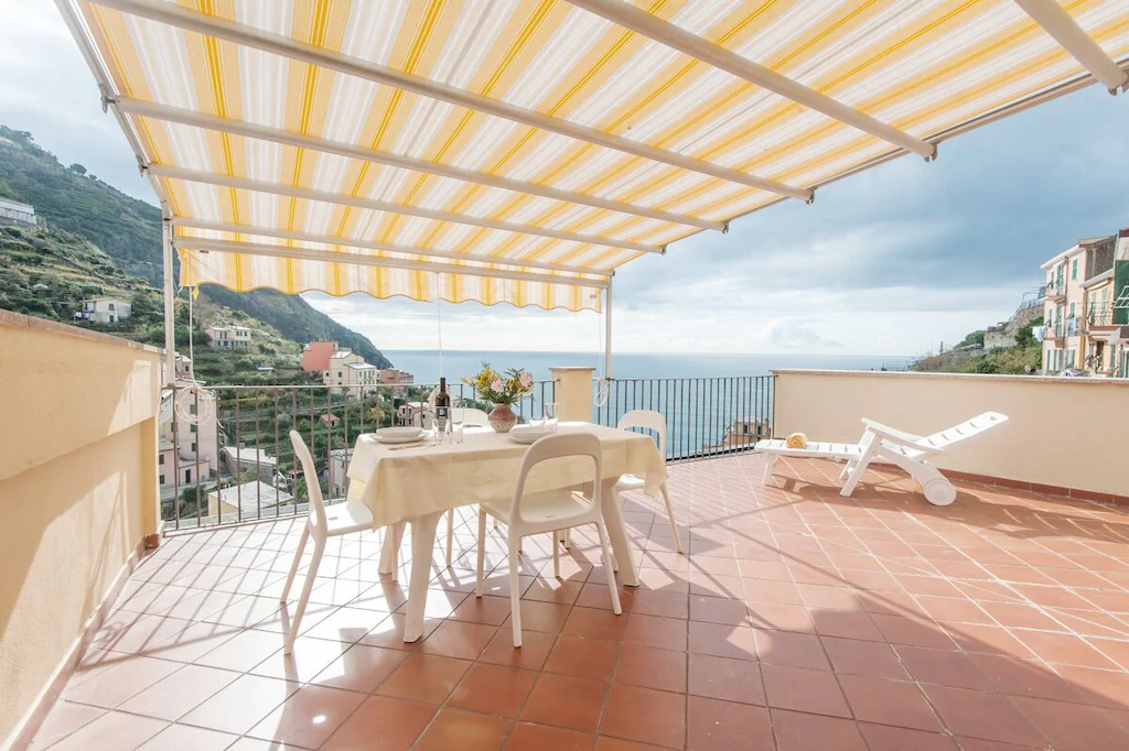 vacation rental in cinque terre italy with yellow umbrella