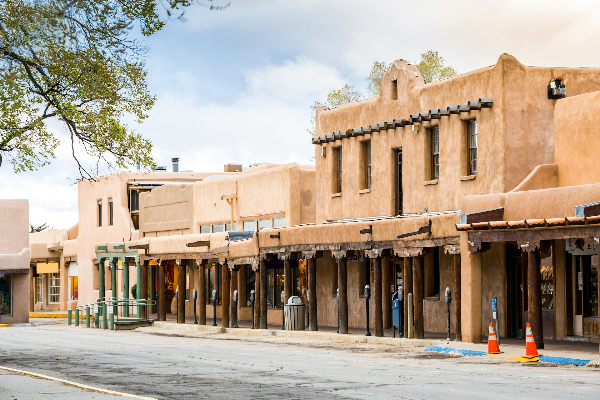 beige sandstone buildings lining street small towns in America