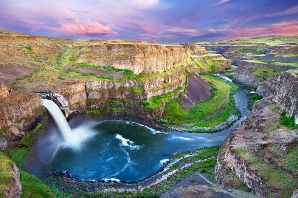 Vivid sunset over Palouse Falls cascading into a gorge.