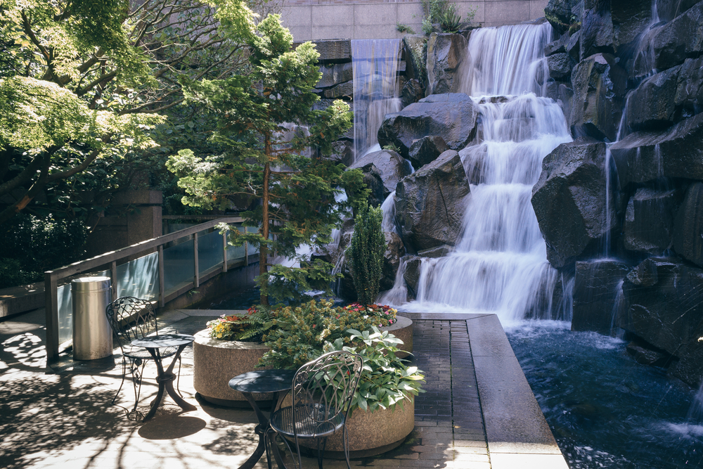 The UPS Waterfall Garden with a tiered waterfall and potted plants.