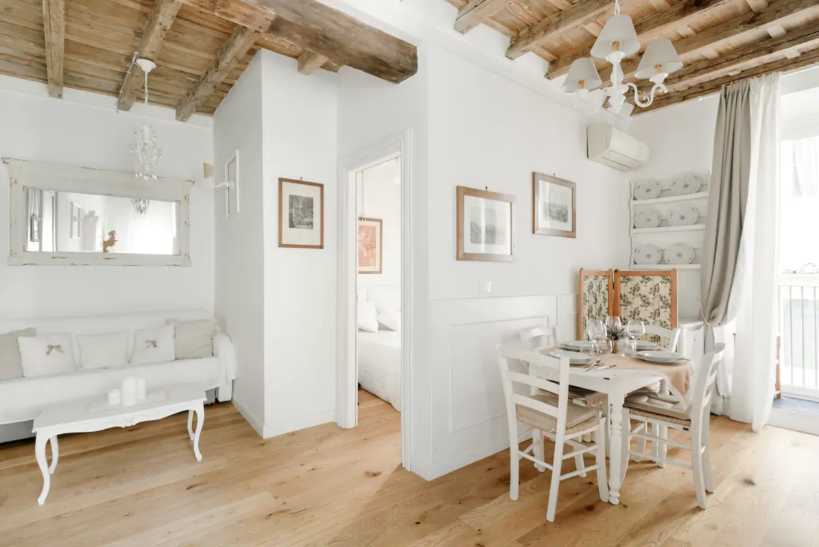 this airbnb in rome is sdecorated with white walls and shabby chic style