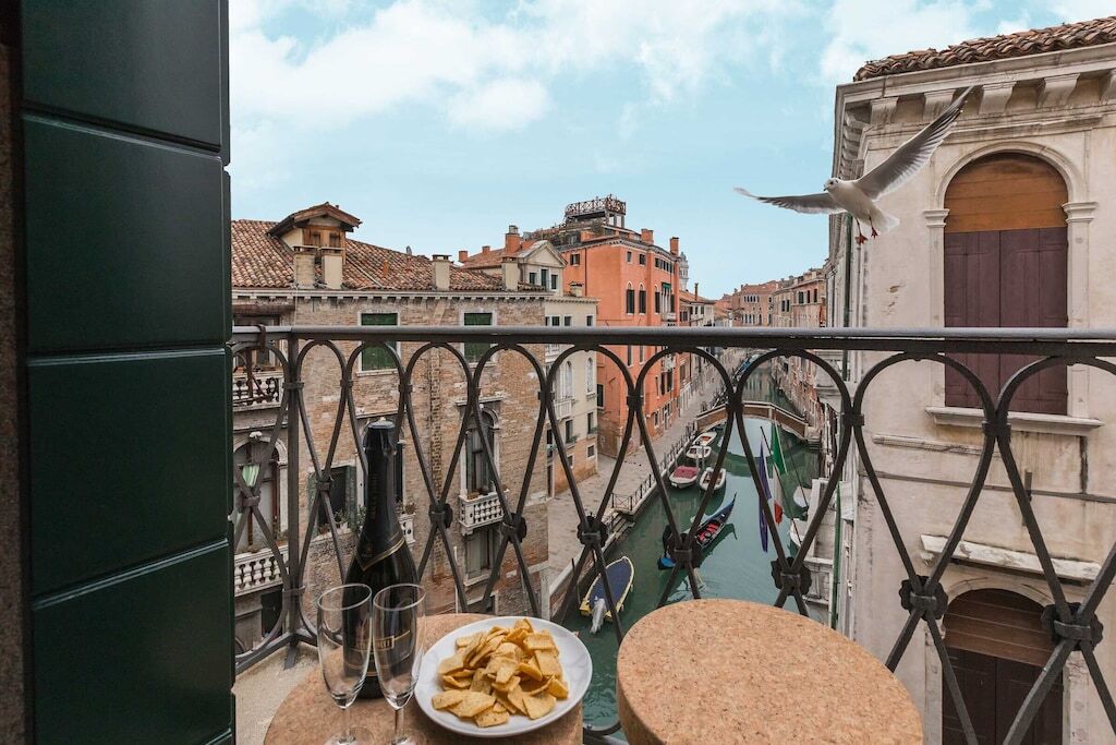 view of a beautiful meal on the balcony overlooking the castello canal
