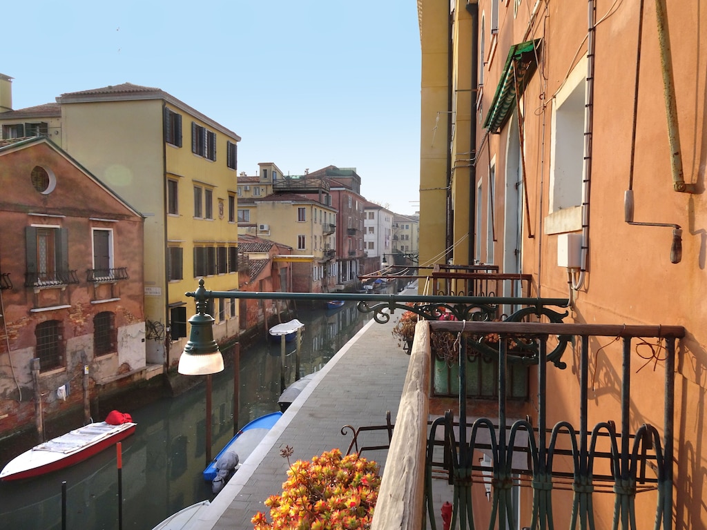 View of the canal from the balcony of this entry on our list of the best airbnbs in Venice, Italy