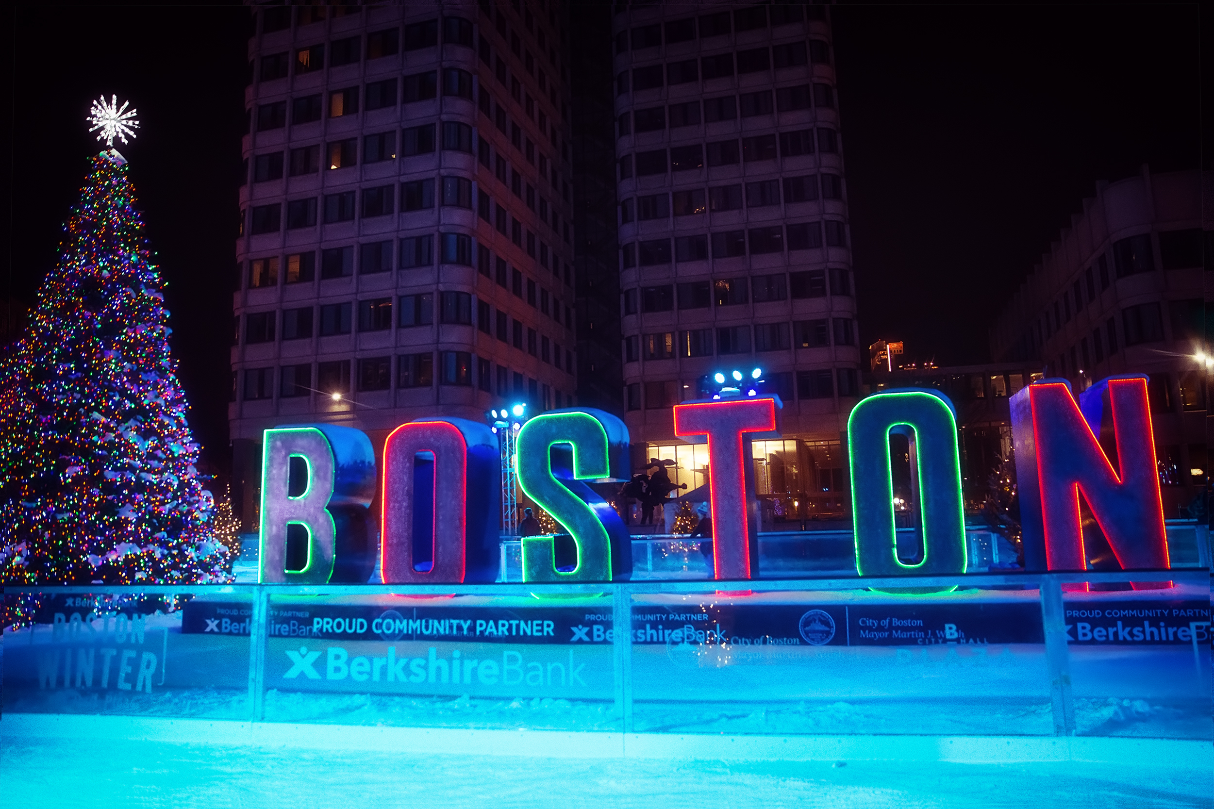 Photo of an outdoor ice rink in Boston during Christmastime.