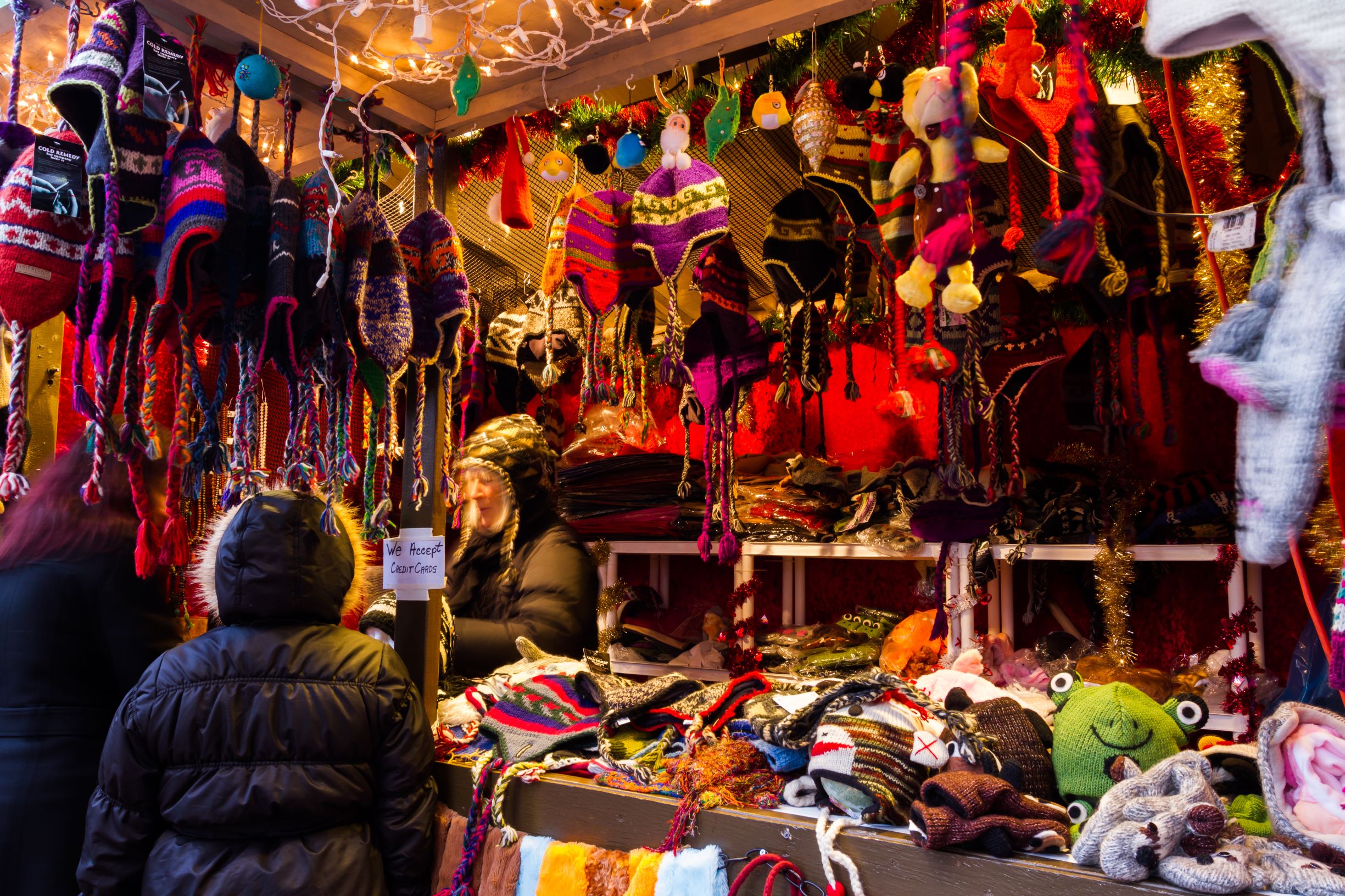 Photo of alpaca wool gifts vendor at a ChristKindl Market, one of the best Christmas markets in the USA.