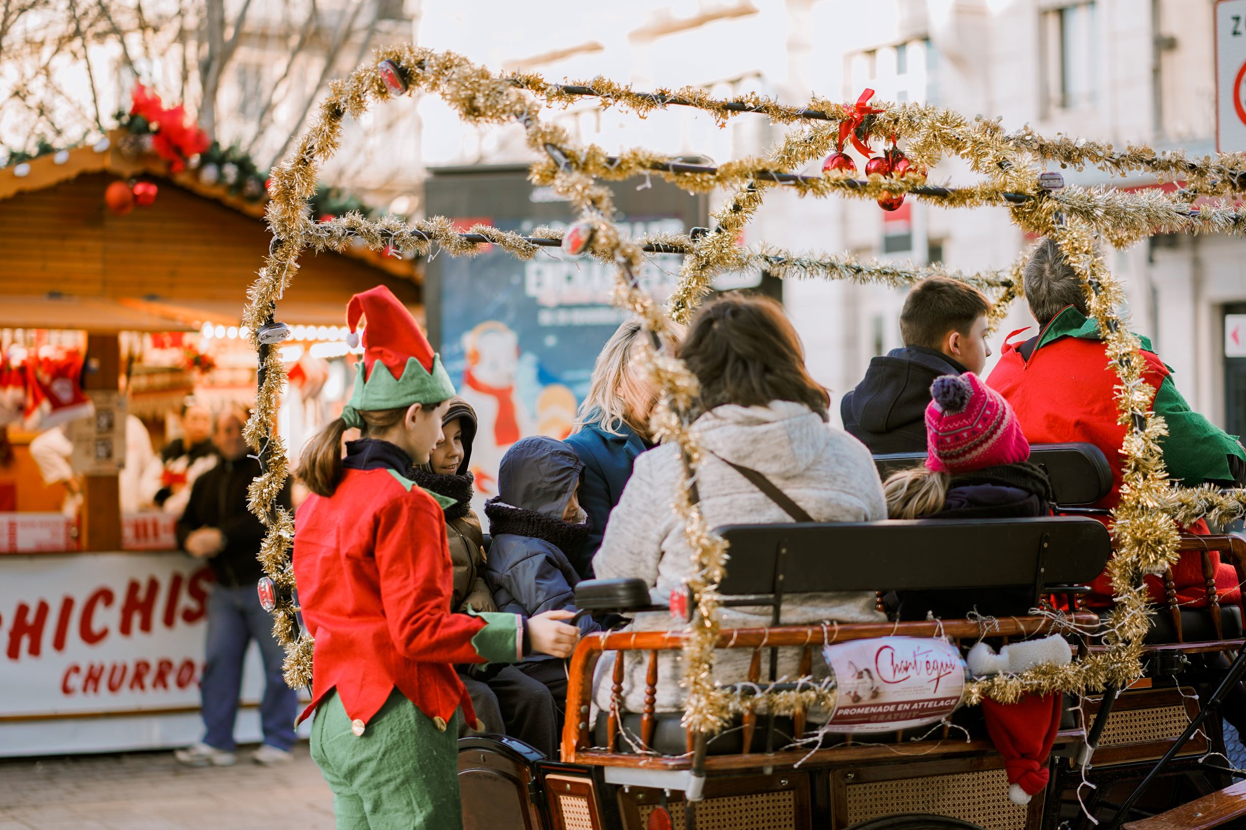 Photo of carriage rides with an elf at a Christmas market.