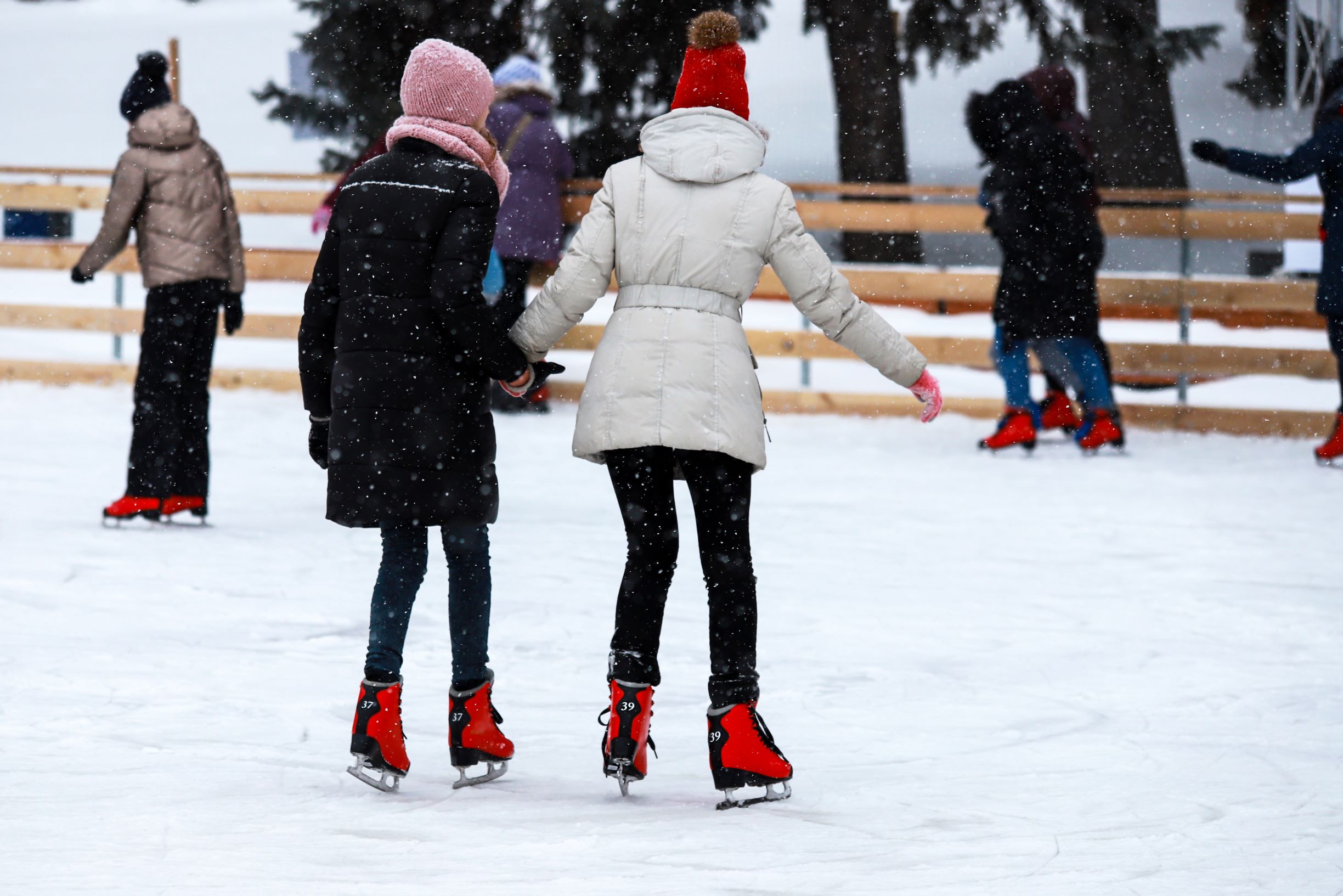 Photo of people skating on an outdoor ice rink.