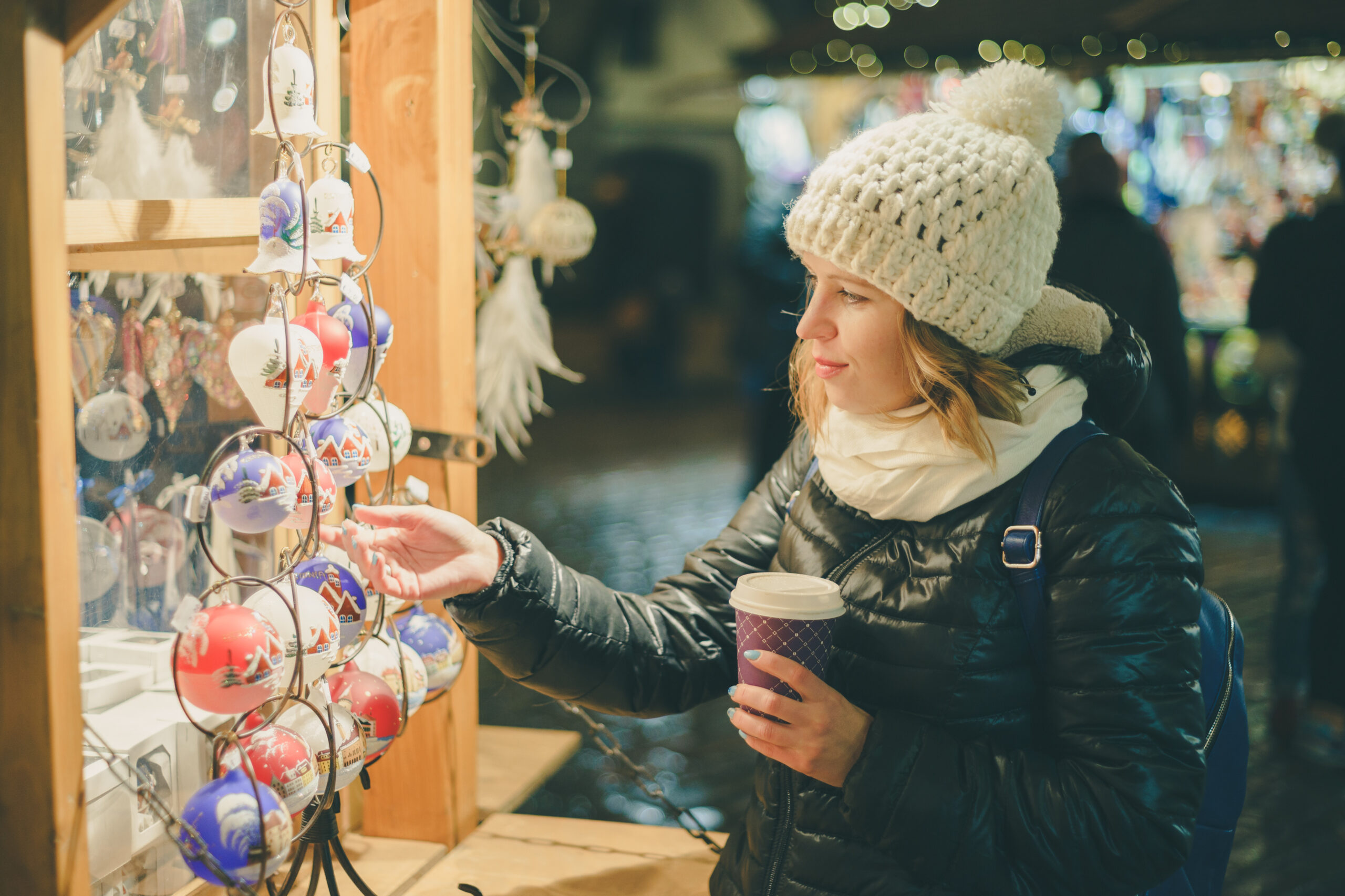 Photo of a woman looking at Christmas ornaments.