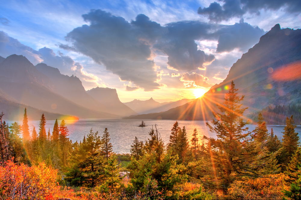 sunrising over mountains and shining on fall trees fall in the USA