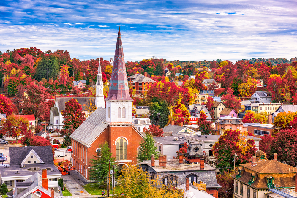 Aerial view of Montpelier with church at the center dotted with autumn-colored trees.