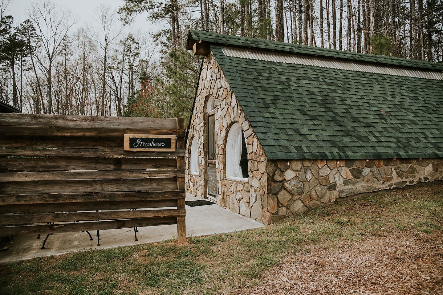 Photo of the outside of an elegant stone greenhouse North Carolina Airbnb.