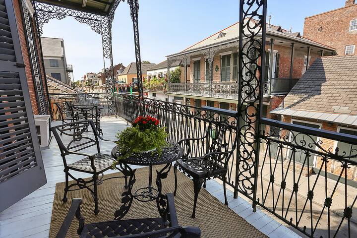 This French Lux Balcony overlooks Bourbon street and is one of the prettiest Airbnbs in the United States