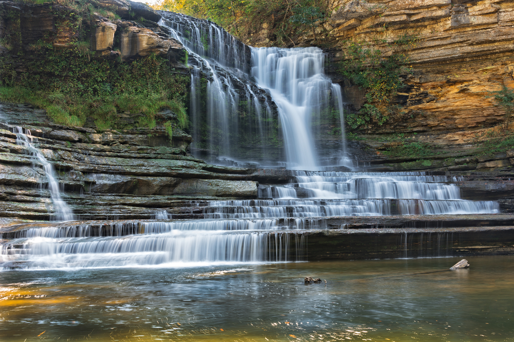 waterfall cascading down natural rock steps weekend getaways in Tennessee