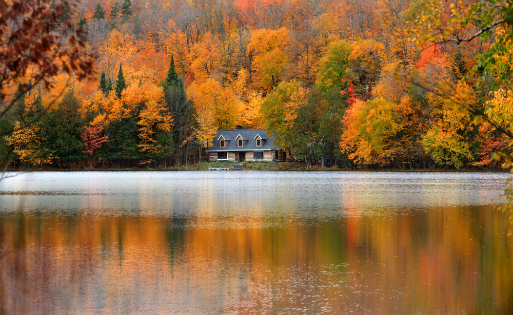 the beautiful reflections of the leaves in Lake Ouimet make it a stunning place to see fall in canada