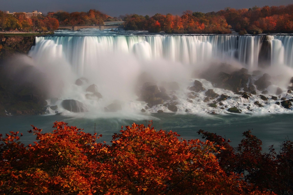 expect beautiful reds to contrast with the blue waters of Niagara falls in canada