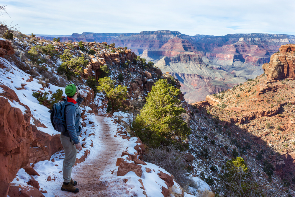 start bright angel trail tourist backpacker winter landscape of Grand Canyon National Park's South Rim