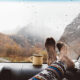 A passenger puts her socks up on the dashboard while it rains