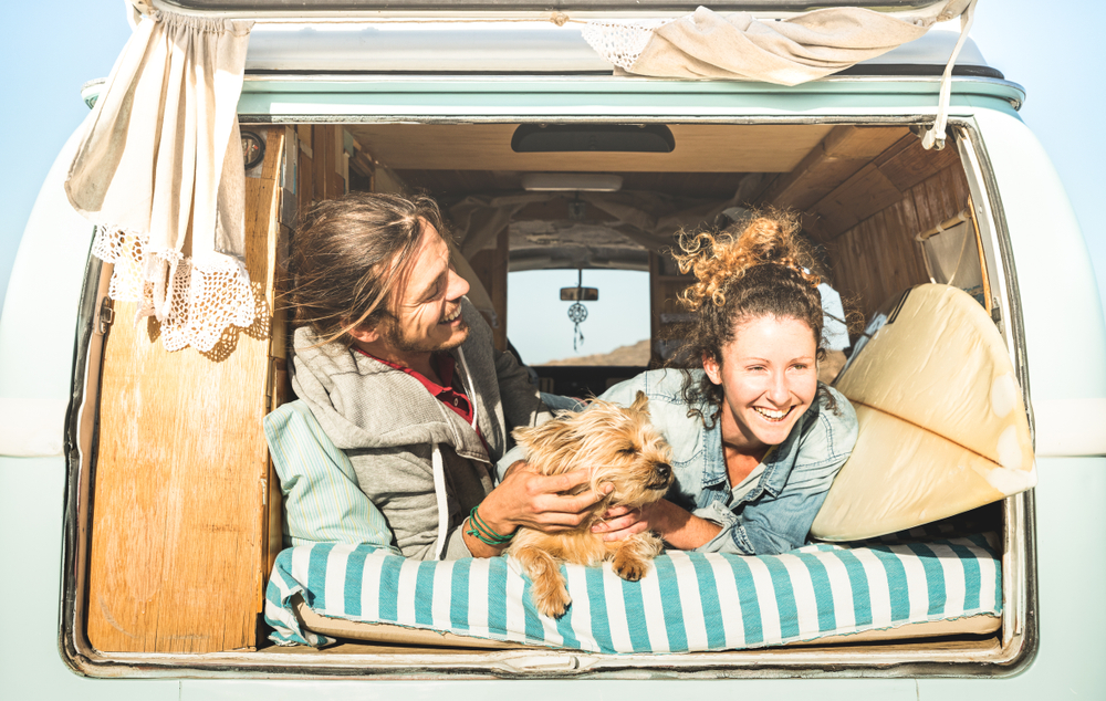 A couple and dog chill in the back of their van