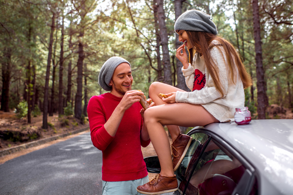 A couple snacks outside their car