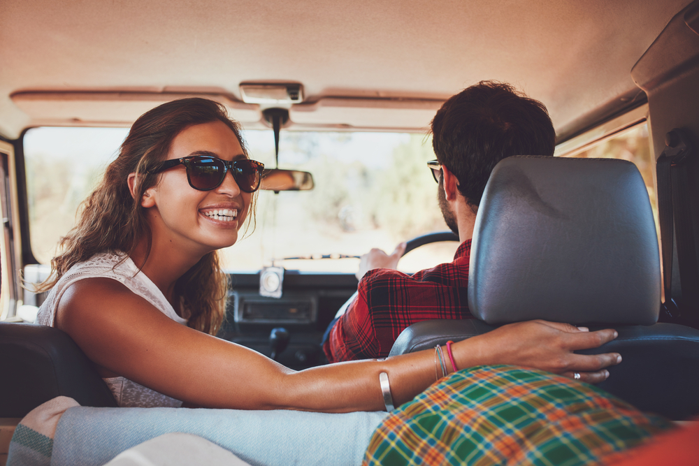 A woman wears sunglasses in the car