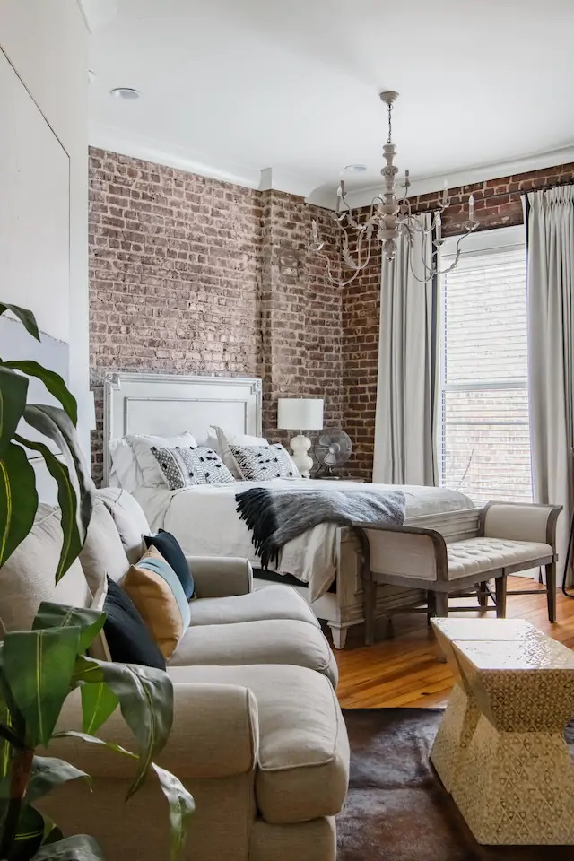 Photo of the inside of a historic Knoxville loft Airbnb showing the bedroom and living room. 