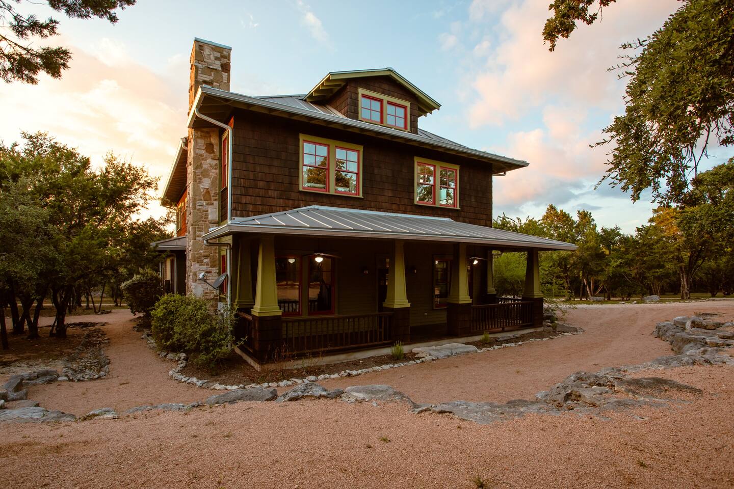 Photo of the exterior of Grit & Grace, one of the best vacation rentals in Texas. It has cedar siding and a tin roof.