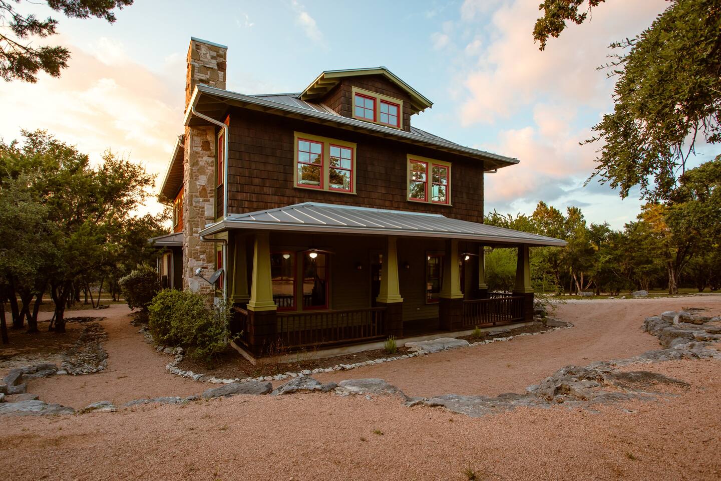 Photo of the exterior of Grit & Grace, one of the best vacation rentals in Texas. It has cedar siding and a tin roof. 