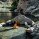 woman sitting in one of the best hot springs in california