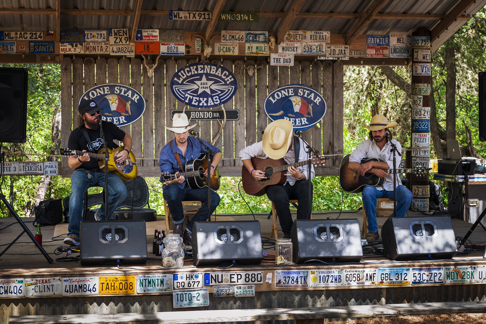 band of four cowboys playing guitars day trips from Austin