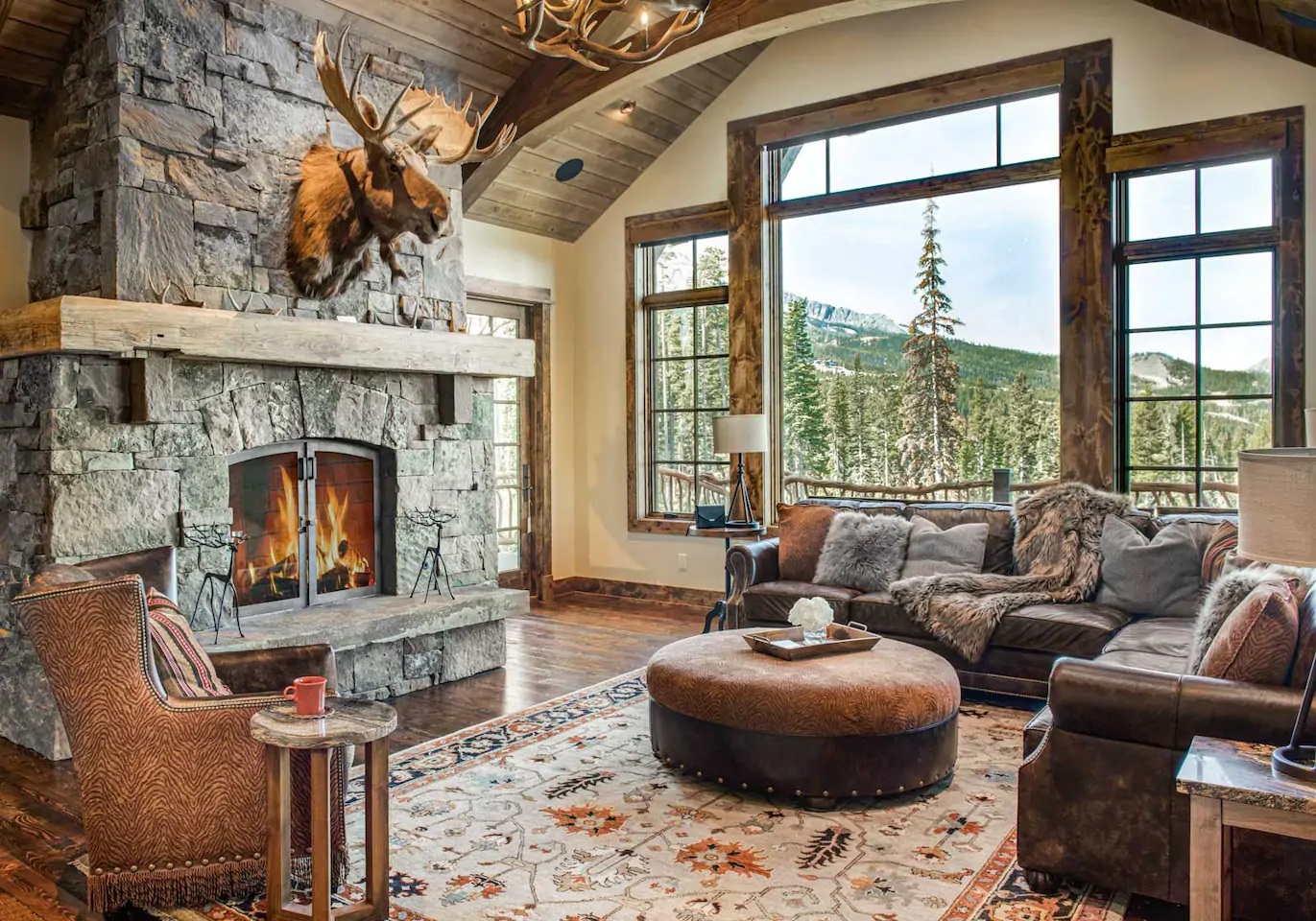 Photo of living room with fireplace inside a mountain chalet Airbnb.