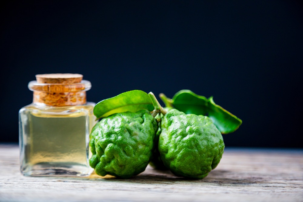 Bergamot essential oil on a wood surface