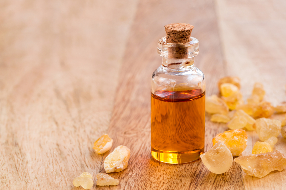 Frankincense on a wooden table and in a  bottle  