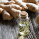 Ginger oil on a table with some raw ginger