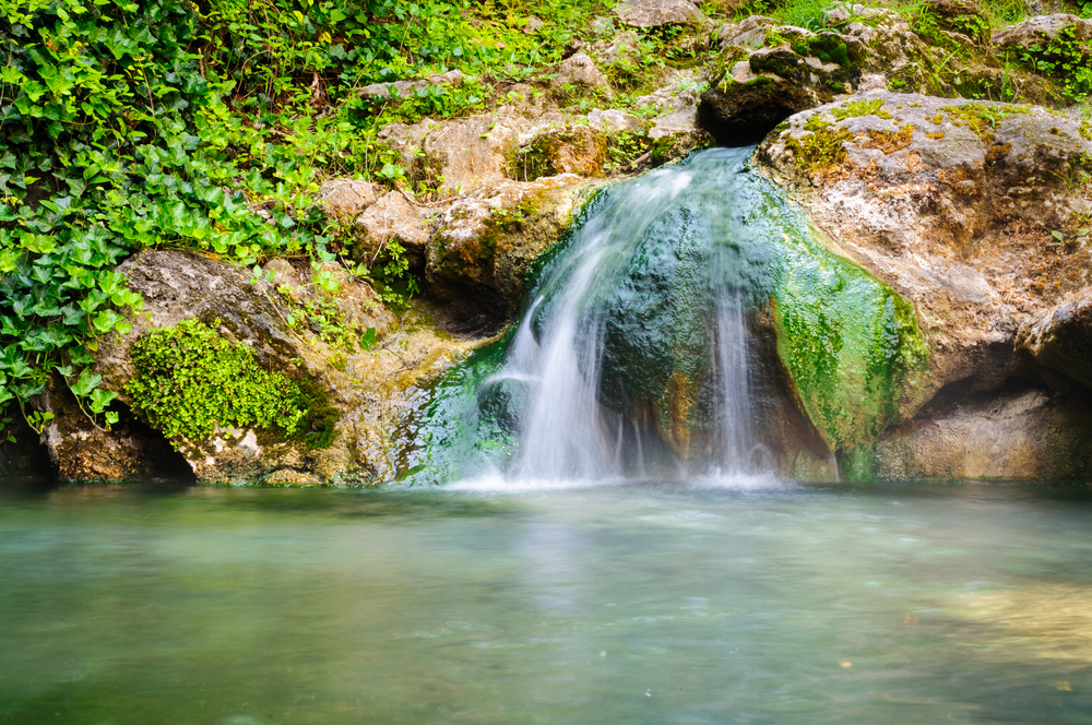 The Hot Springs National Park features warm waters and slight falls in the middle of mountains!