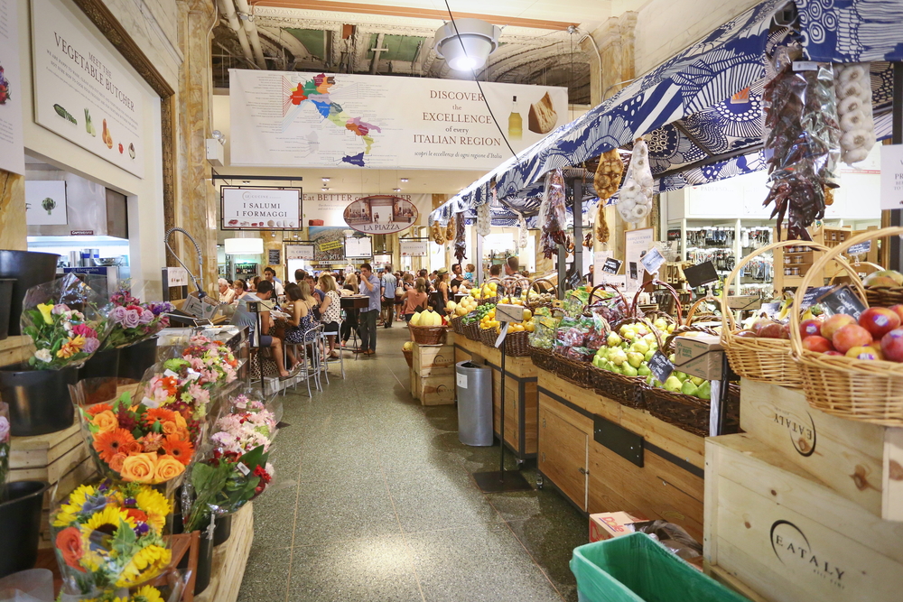 Food and flower stalls in Eataly, a large Italian grocery store, one of the most unusual things to do in New York