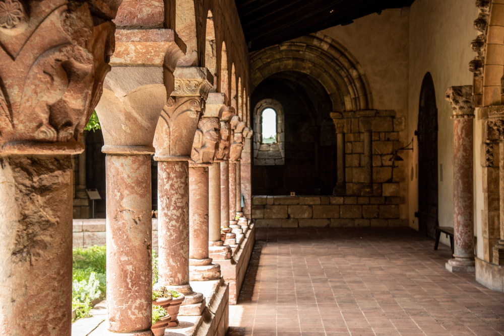 A passageway with columns at the MET Cloisters, one of the most unusual things to do in New York