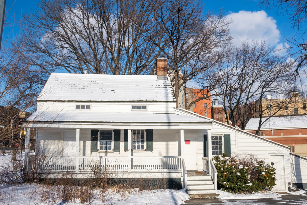 The front of Poe Cottage after a snowfall, one of the most unusual things to do in New York