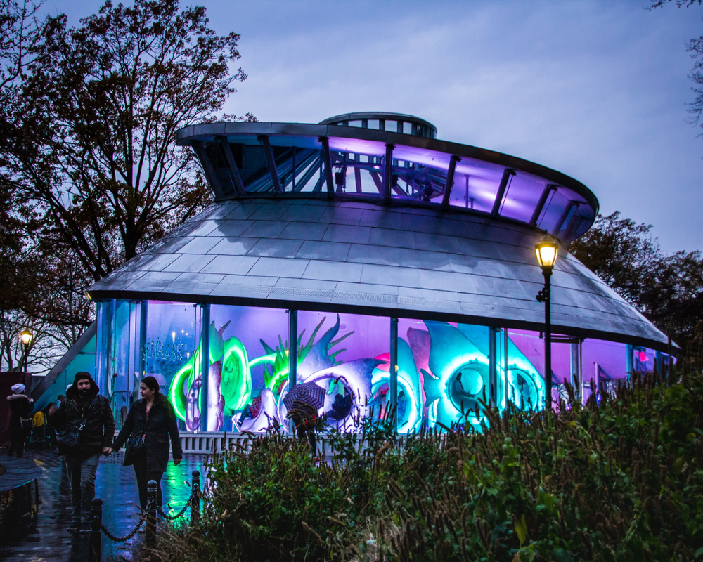 The outside of the SeaGlass Carousel lit up at night, one of the most unusual things to do in New York