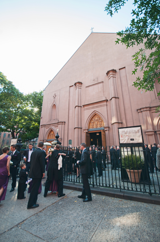 A large group of people standing outside of St. Patrick's Basilica,