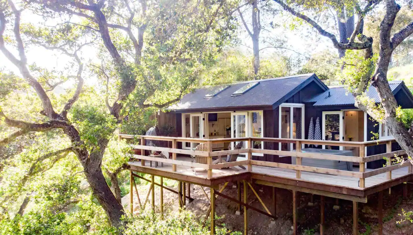 Beautiful treehouse, nestled into the oak trees, with a big wrap around deck and hot tub, one of the best California Airbnbs in Carmel Valley.
