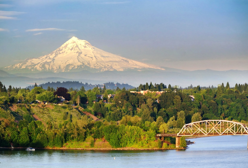 a scenic bridge lots of trees and and Mt Hood in the distance, enjoying nature is one of the best things to do in Portland, Oregon