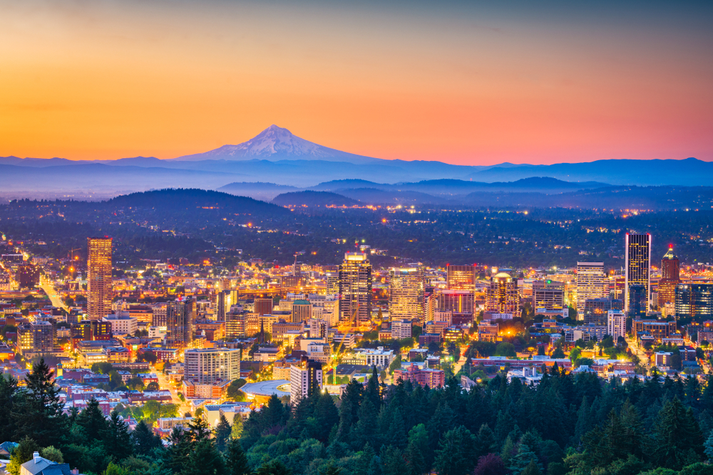 The Portland city skyline at sunset with beautiful Mt Hood visible in the background.