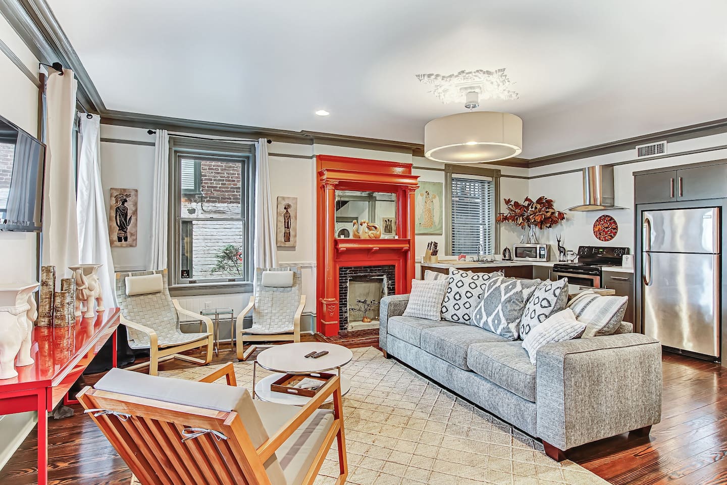 Bright red accents make this modern and stylish apartment stand out among all the airbnbs in Savannah