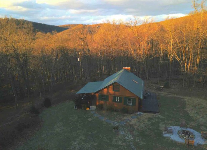 Overhead view of a cozy cabin in Maryland surrounded by forest